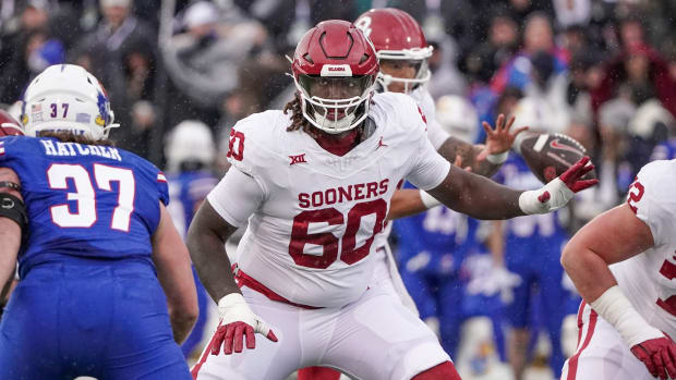 Oklahoma Sooners offensive lineman Tyler Guyton (60) at the line of scrimmage against the Kansas Jayhawks during the game at David Booth Kansas Memorial Stadium.